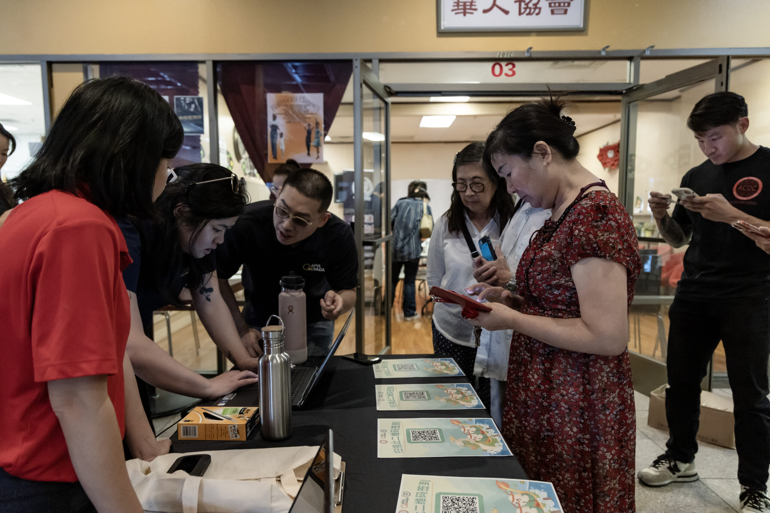 Members of the Las Vegas Asian community receive information on how to vote in Chinese during the annual Dragon Boat Festival in Las Vegas on Wednesday, June 5, 2024. Advocates are working to help non-English speakers access voting materials in their primary language. (Photo by Christopher Lomahquahu/News21)