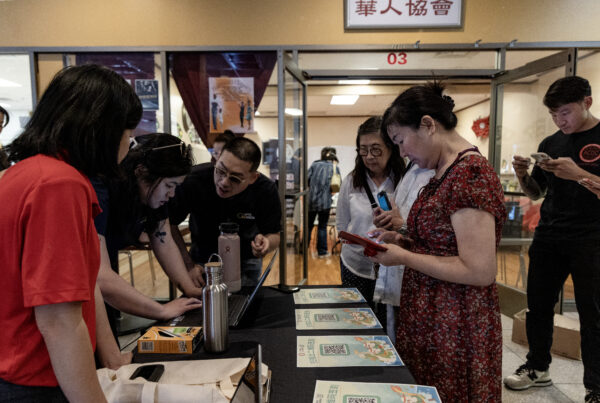 Members of the Las Vegas Asian community receive information on how to vote in Chinese during the annual Dragon Boat Festival in Las Vegas on Wednesday, June 5, 2024. Advocates are working to help non-English speakers access voting materials in their primary language. (Photo by Christopher Lomahquahu/News21)