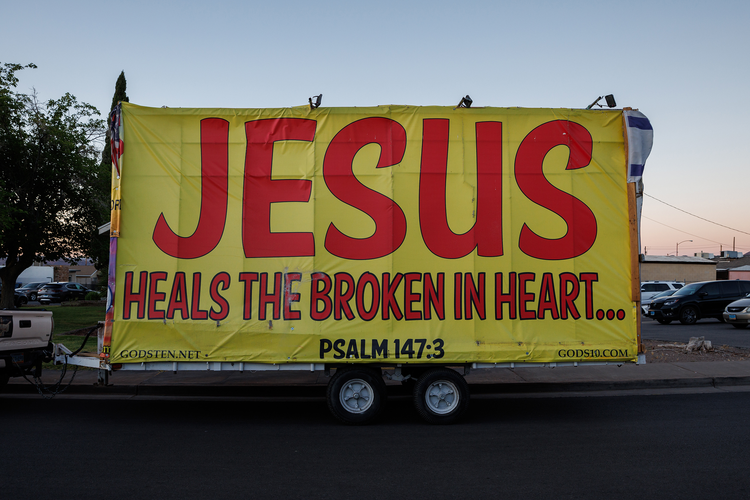 A trailer plastered with signs sits outside the First Baptist Church of Henderson in Henderson, Nev., Friday, June 28, 2024. The church was the site of a screening of “Let My People Go,” a documentary about Jan. 6ers. (Photos by Hudson French/News21)