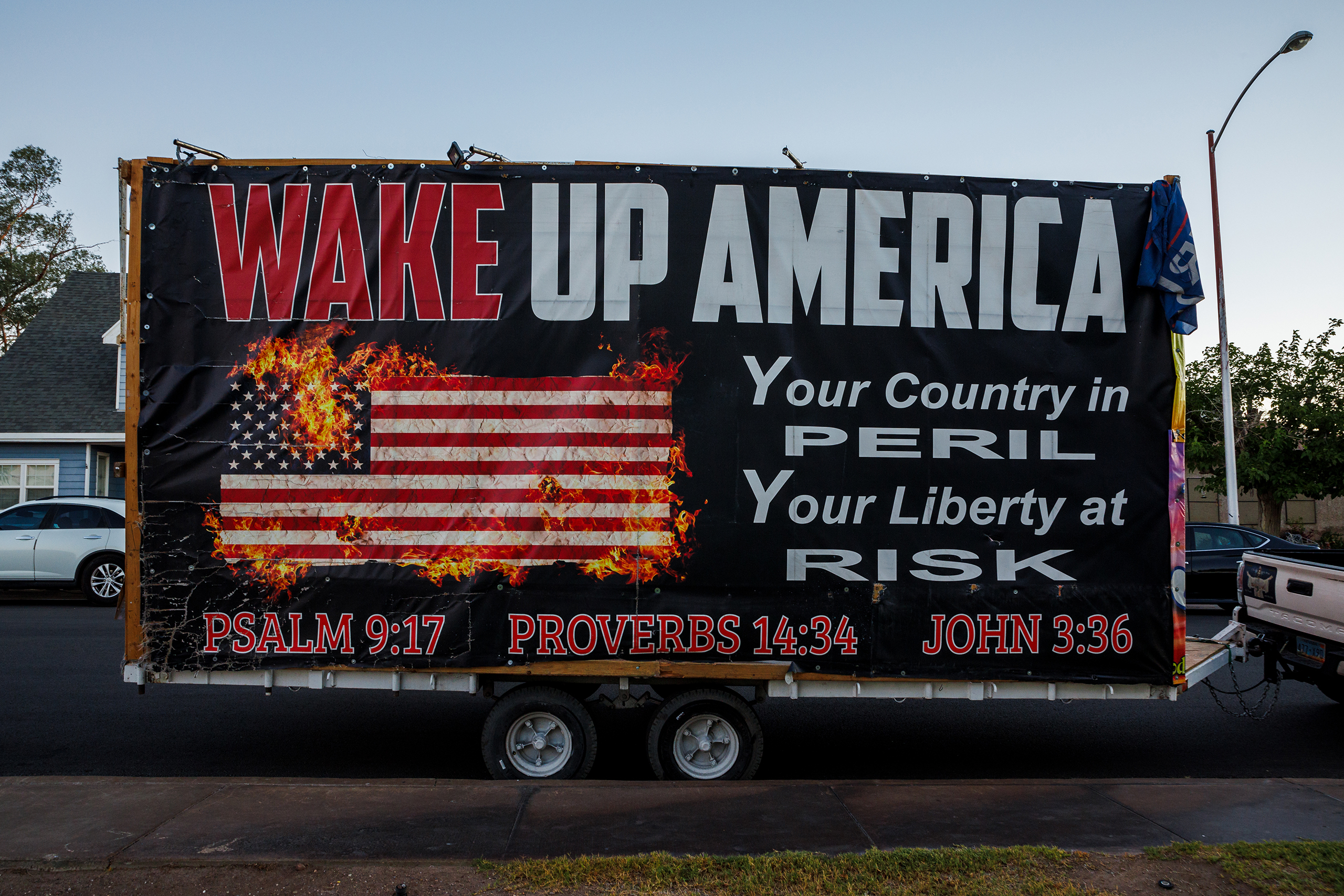 A trailer plastered with signs sits outside the First Baptist Church of Henderson in Henderson, Nev., Friday, June 28, 2024. The church was the site of a screening of “Let My People Go,” a documentary about Jan. 6ers. (Photos by Hudson French/News21)