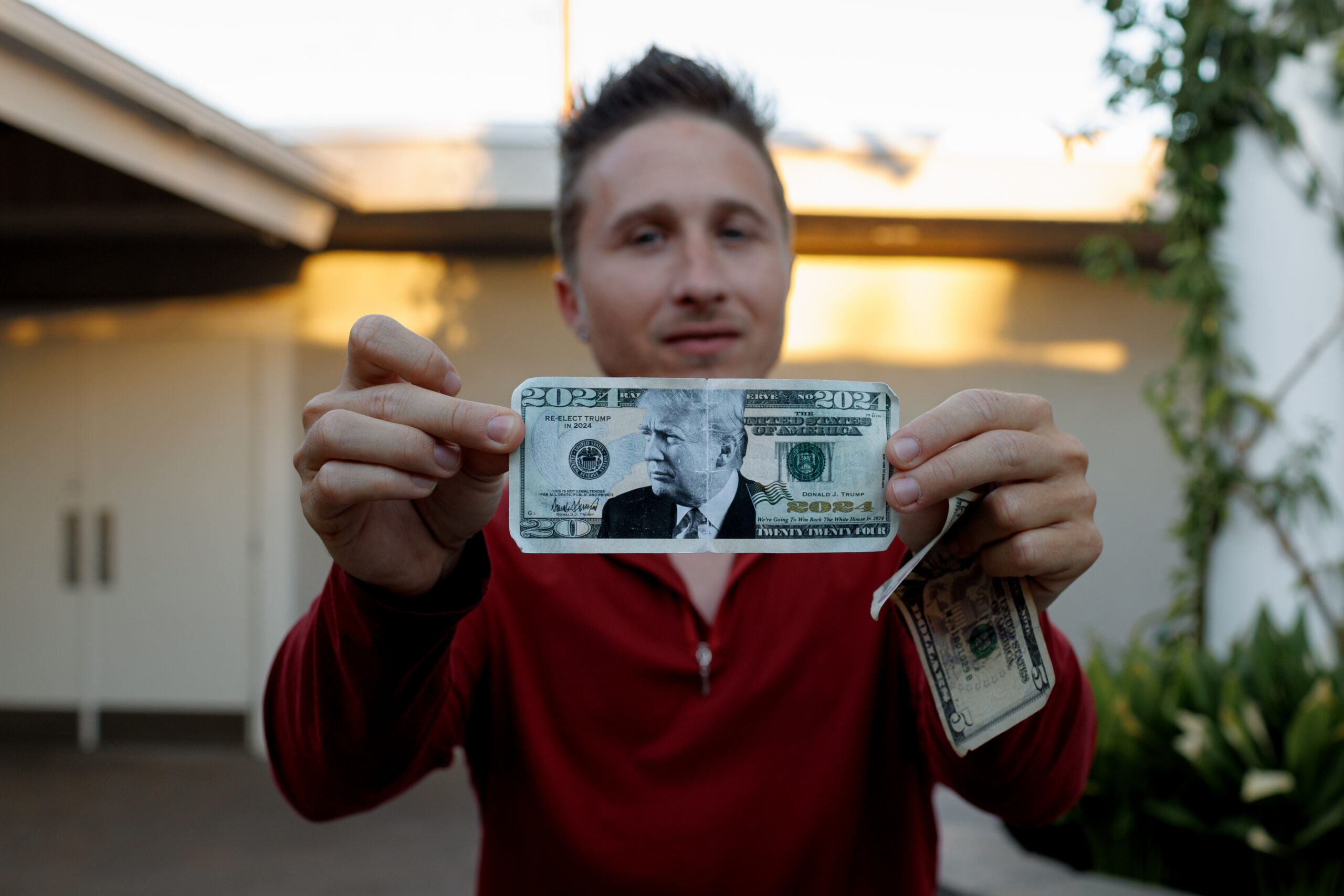 Nathan DeGrave displays his so-called “Trump money” after giving a speech on Friday, June 28, 2024, at a church in Henderson, Nev., about his time in prison stemming from his role in the Capitol insurrection. (Photo by Hudson French/News21)