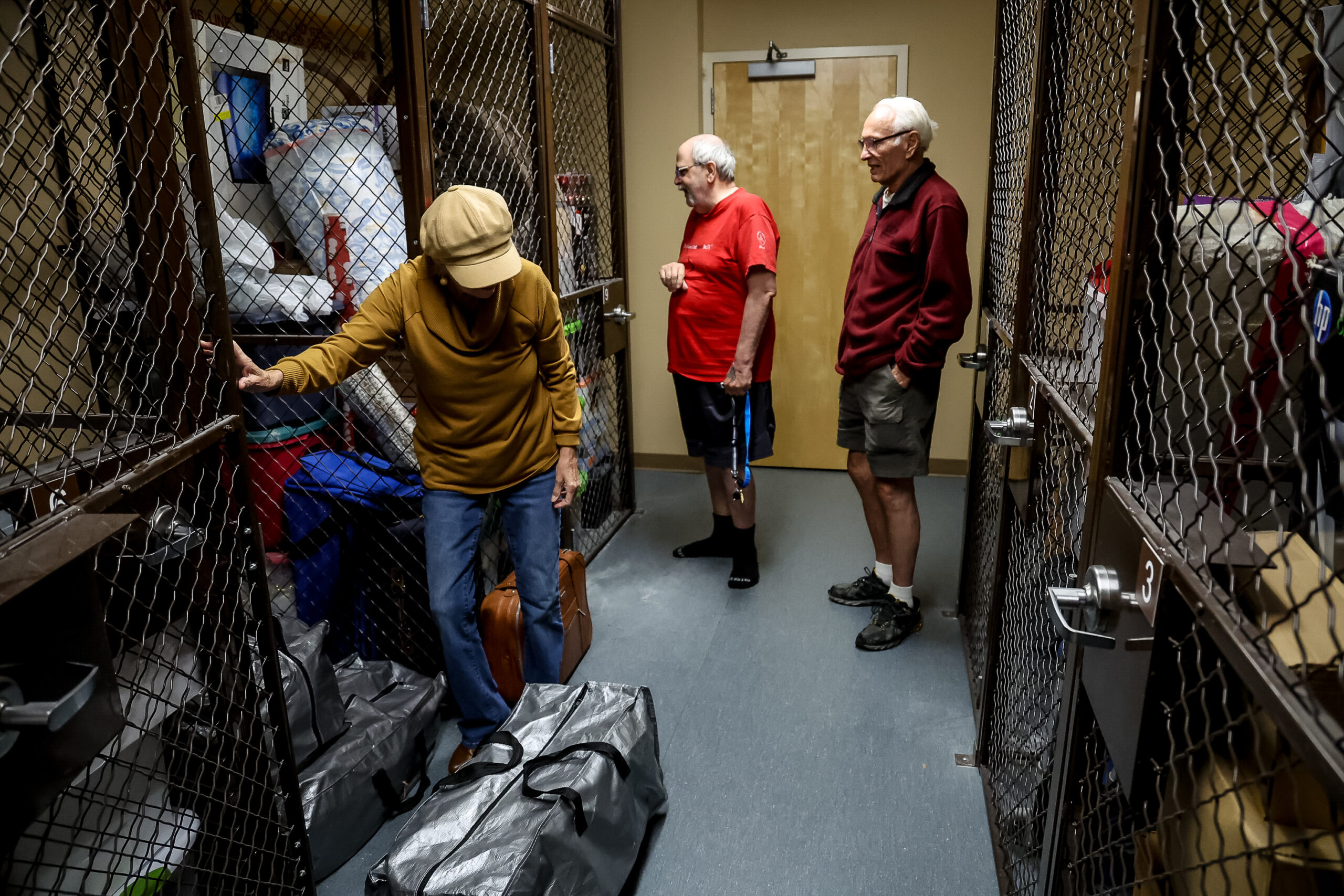 Pamela Hemphill unpacks a variety of self-help books at her apartment in Boise, Idaho, on June 17, 2024. Hemphill served two months in prison for her actions at the Jan. 6, 2021, insurrection at the Capitol and has since become an outspoken critic of former President Donald Trump. (Photo by Donovan Johnson/News21)