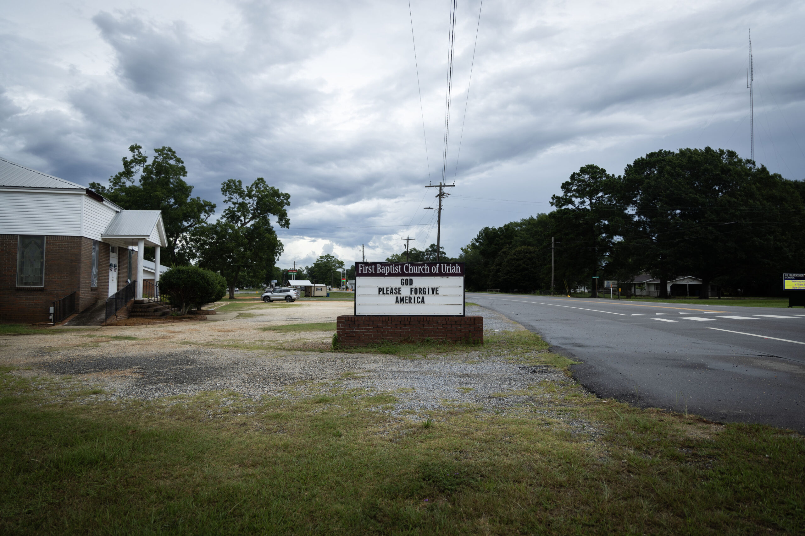 “God please forgive America” reads a sign outside of Alabama’s First Baptist Church of Uriah on June 16, 2024. (Photo by Jordan Moore/News21)