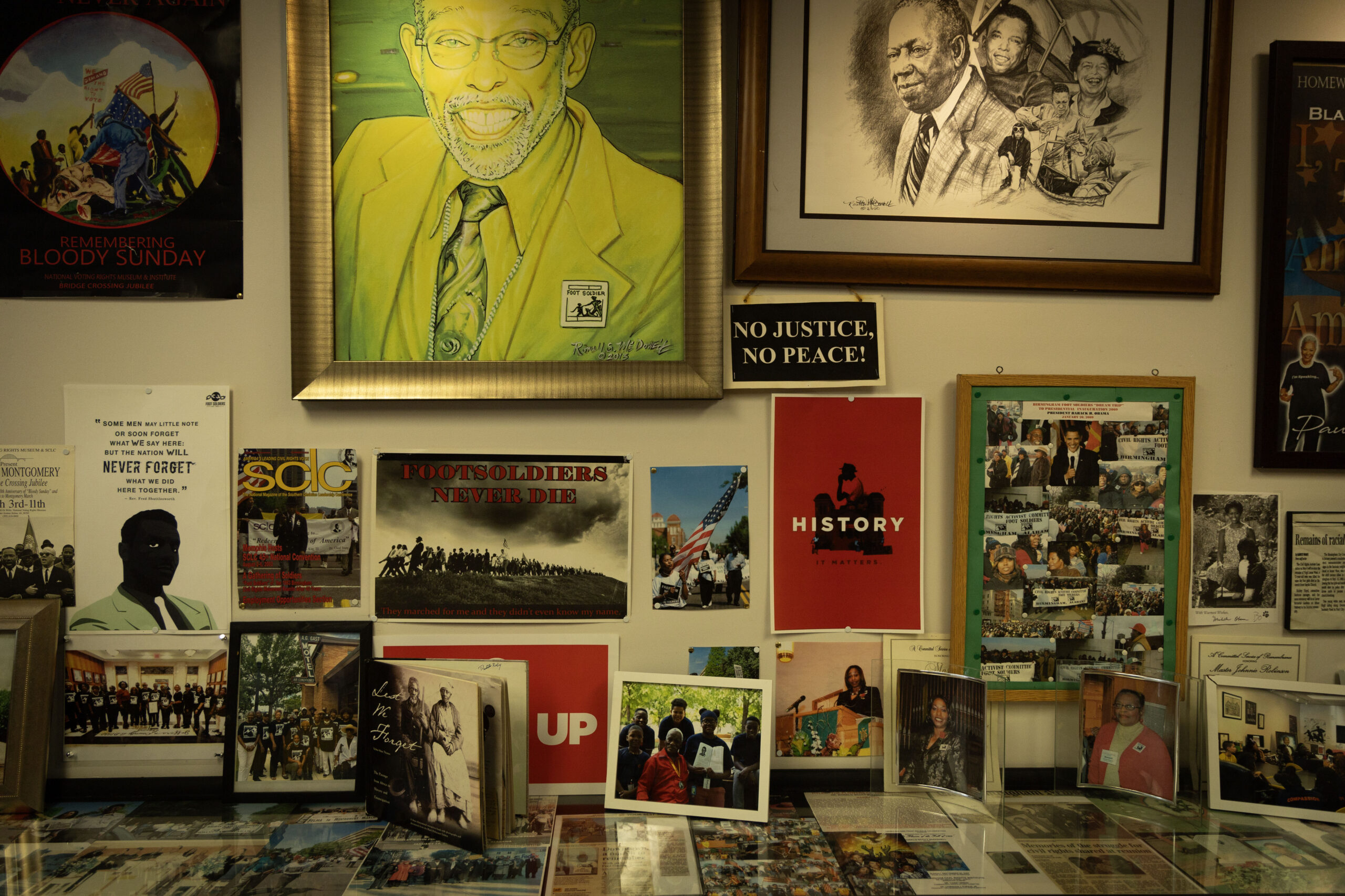 Photos, posters and paintings cover a wall of the Civil Rights Activist Committee Headquarters in Birmingham, Ala., June 17, 2024. The space commemorates the work of the citizens who marched, protested and advocated for civil rights, also known as foot soldiers. (Photo by Jordan Moore/News21)